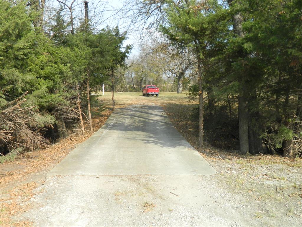 956 County Road 4231 Bonham, TX 75418 - Photo 23 of 25 a sign board with tall trees