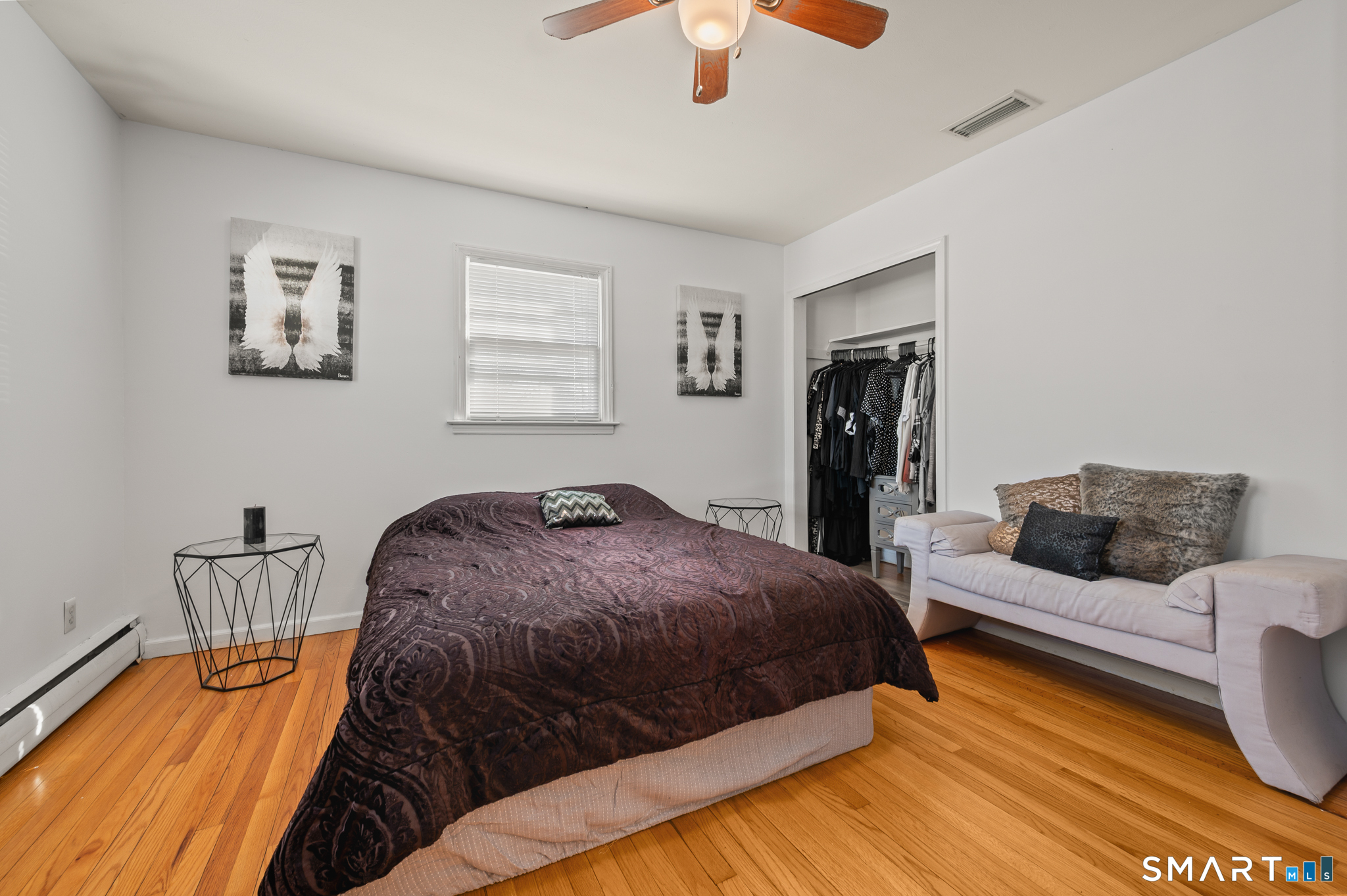 192 Wolcott Hill Road Wethersfield, CT 06109 - Photo 15 of 35 a bedroom with a bed and a chandelier