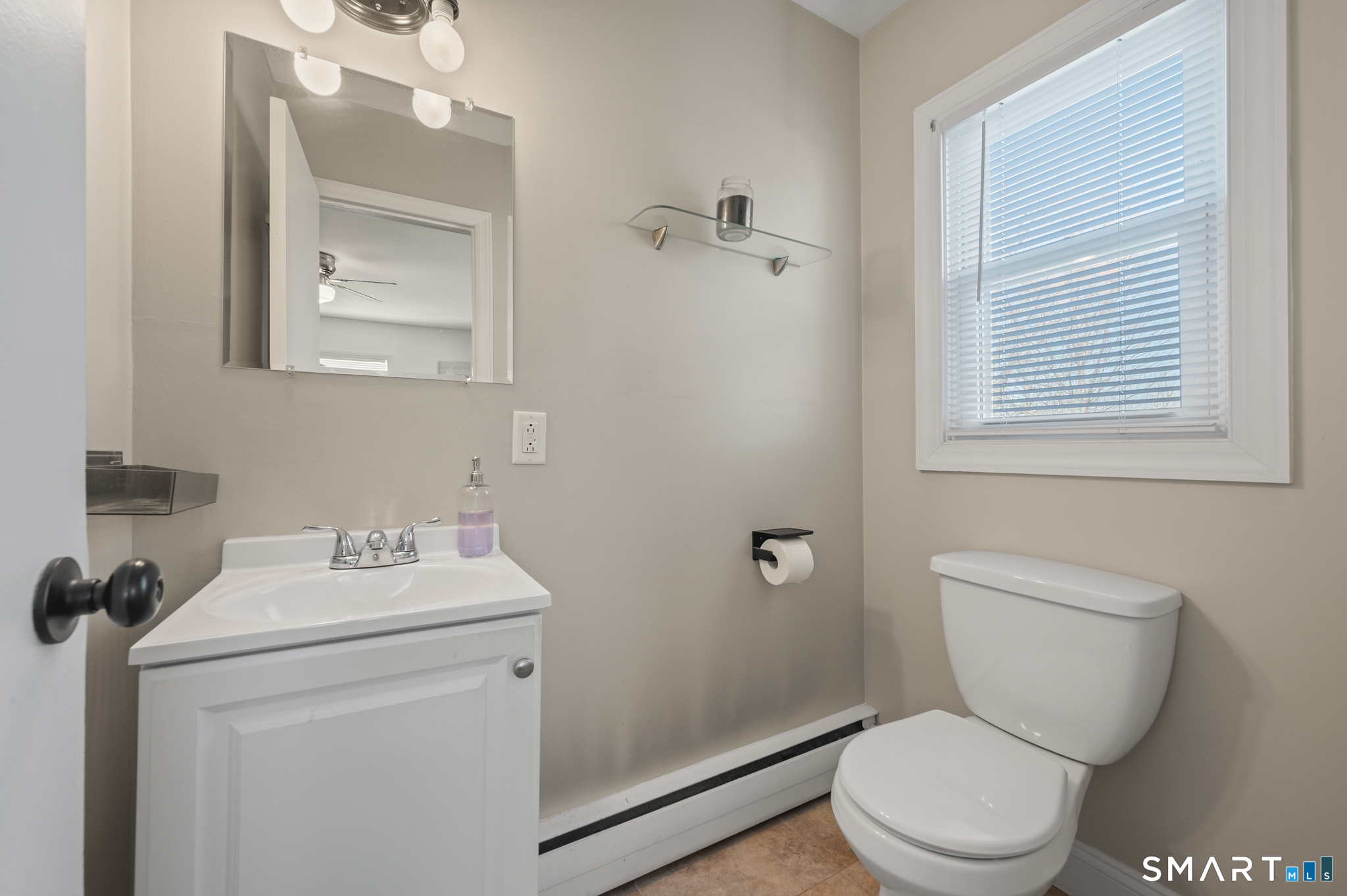 192 Wolcott Hill Road Wethersfield, CT 06109 - Photo 18 of 35 a bathroom with a toilet sink and mirror