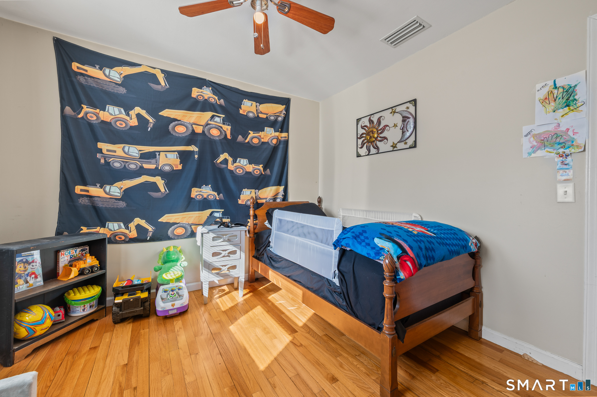 192 Wolcott Hill Road Wethersfield, CT 06109 - Photo 20 of 35 a bedroom with a bed and wooden floor