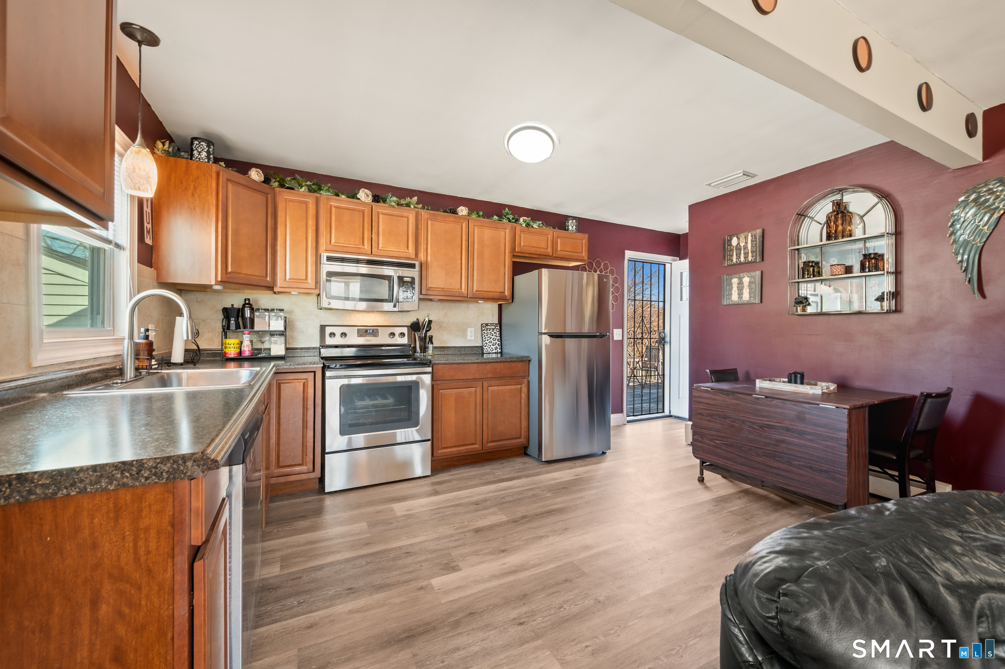 192 Wolcott Hill Road Wethersfield, CT 06109 - Photo 3 of 35 a kitchen with granite countertop a refrigerator oven a sink dishwasher and wooden cabinets with wooden floor