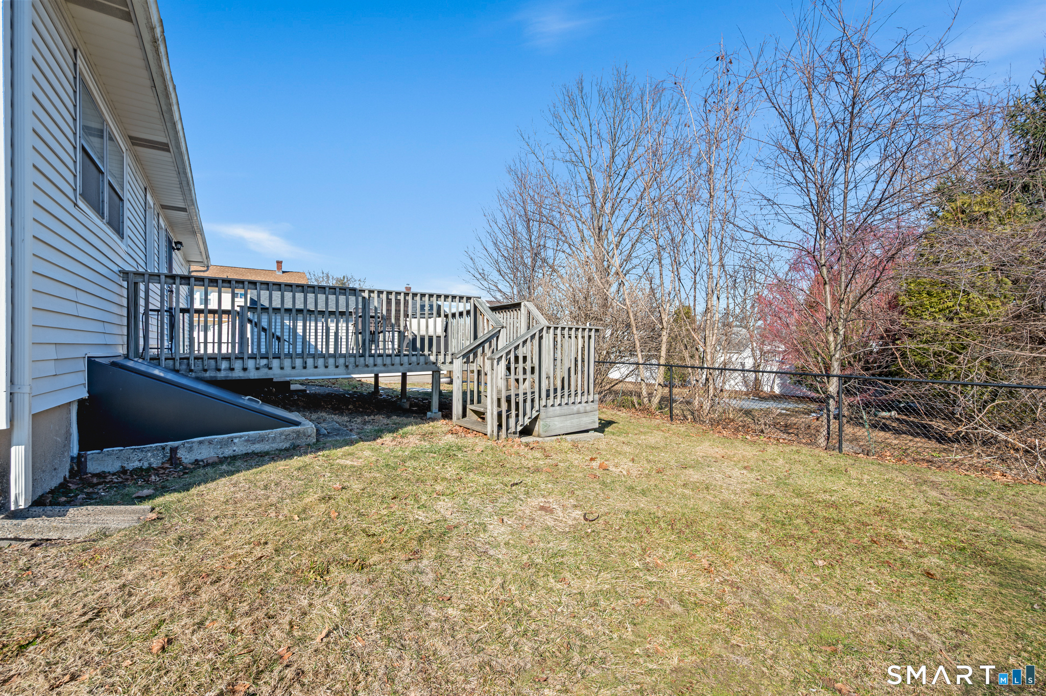 192 Wolcott Hill Road Wethersfield, CT 06109 - Photo 32 of 35 a view of backyard with wooden fence and large trees