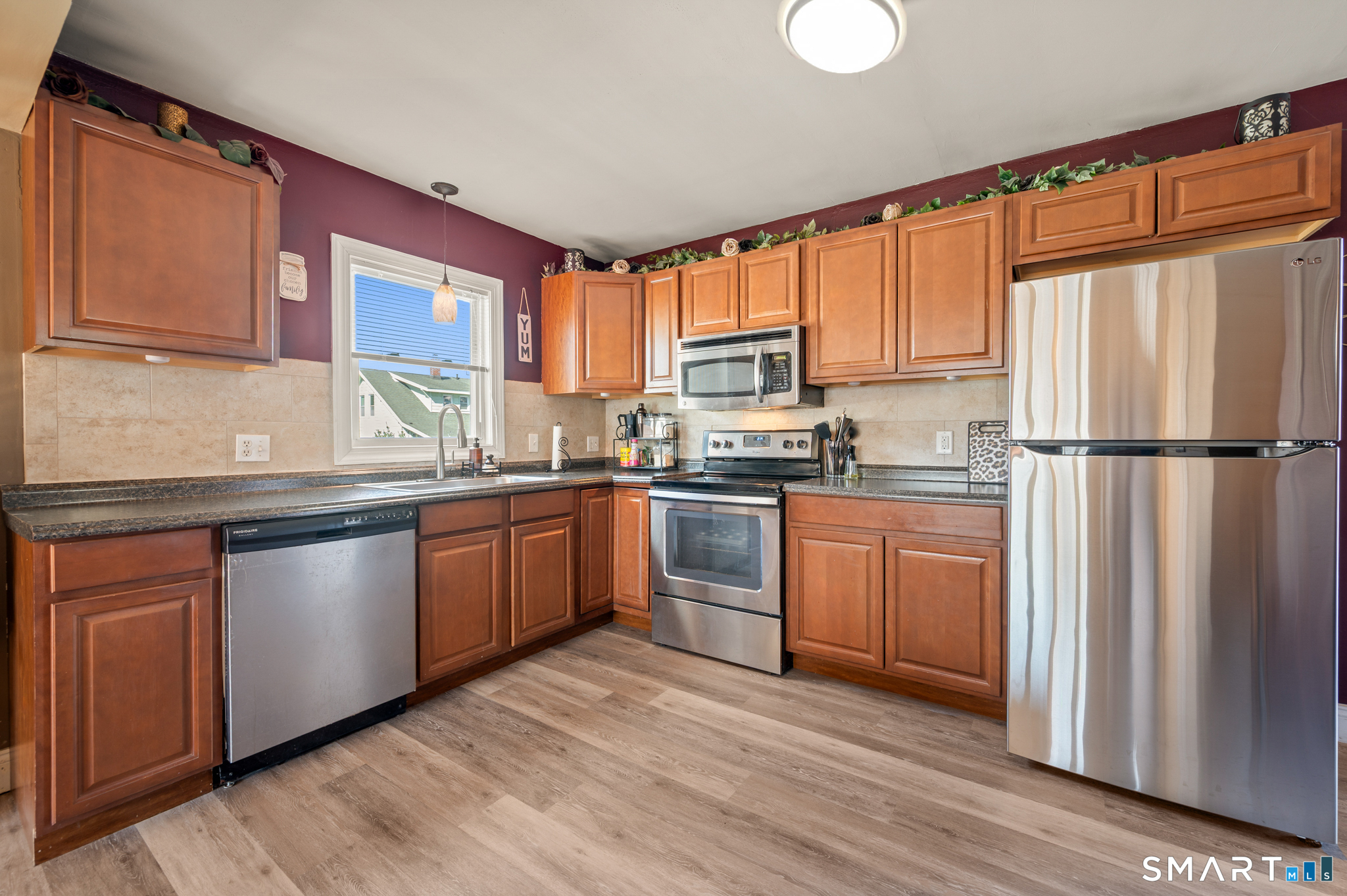 192 Wolcott Hill Road Wethersfield, CT 06109 - Photo 5 of 35 a kitchen with granite countertop wooden floors stainless steel appliances a sink and a window
