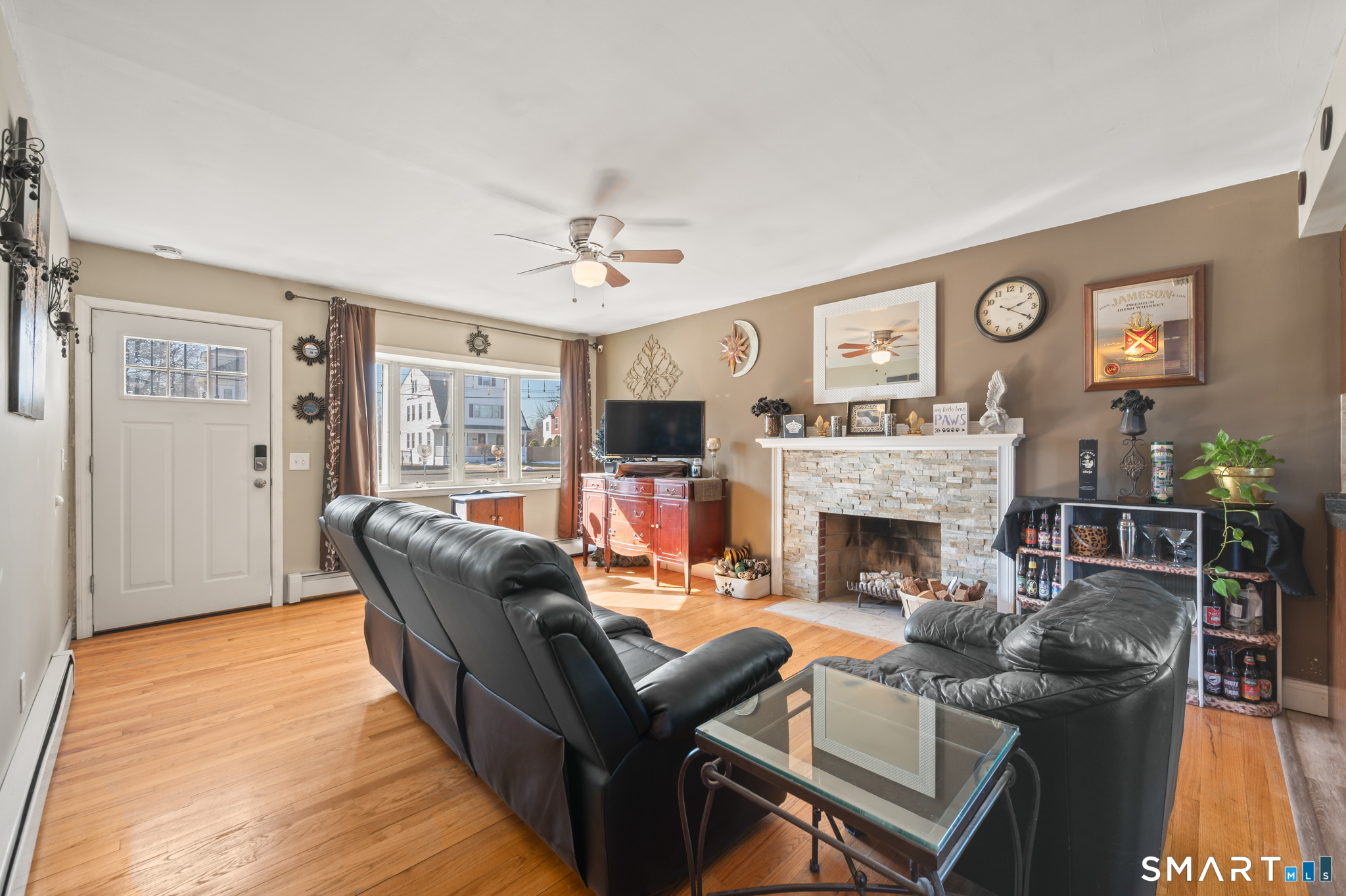 192 Wolcott Hill Road Wethersfield, CT 06109 - Photo 9 of 35 a living room with furniture a flat screen tv and a fireplace