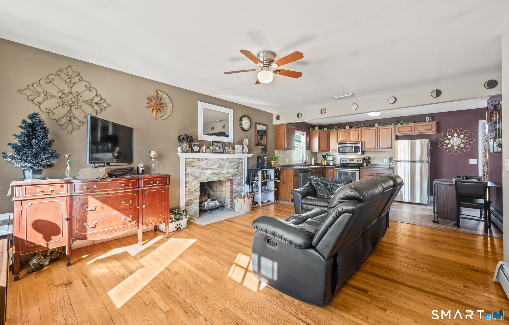 192 Wolcott Hill Road Wethersfield, CT 06109 - Photo 10 of 35 a living room with furniture a fireplace and a flat screen tv
