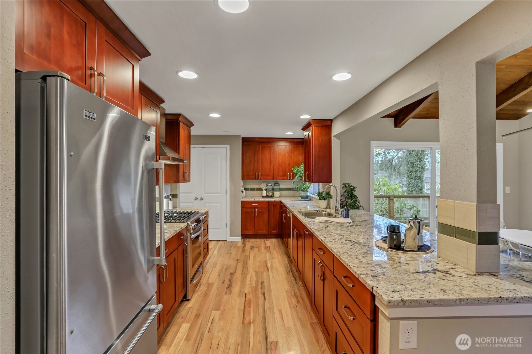 16387 129th Avenue Southeast Renton, WA 98058 - Photo 9 of 30 a kitchen with stainless steel appliances granite countertop a refrigerator and a sink