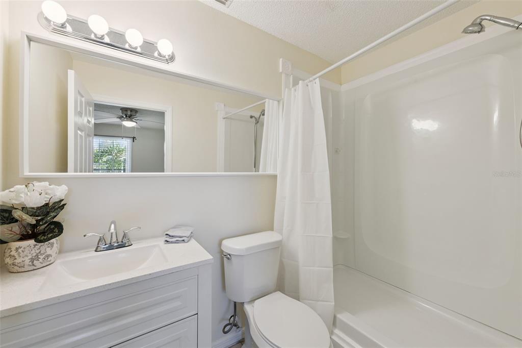212 Ridge Crest Loop, Unit B Minneola, FL 34715 - Photo 13 of 21 a bathroom with a sink a toilet and shower