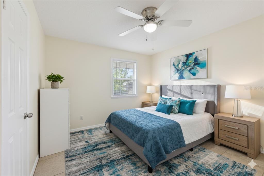 212 Ridge Crest Loop, Unit B Minneola, FL 34715 - Photo 16 of 21 a bedroom with a large bed and a chandelier