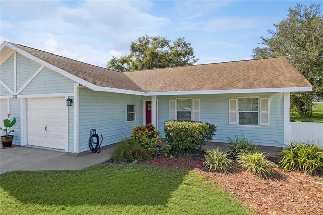 a view of a house with a yard and plants