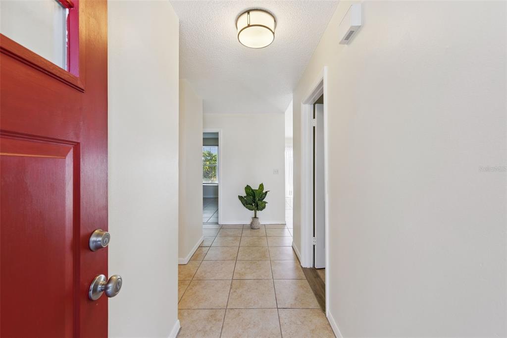 212 Ridge Crest Loop, Unit B Minneola, FL 34715 - Photo 4 of 21 a view of a hallway with paintings on the wall