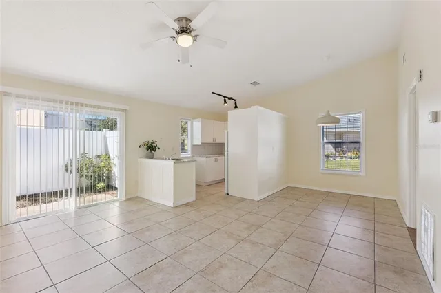 a view of kitchen with furniture and refrigerator