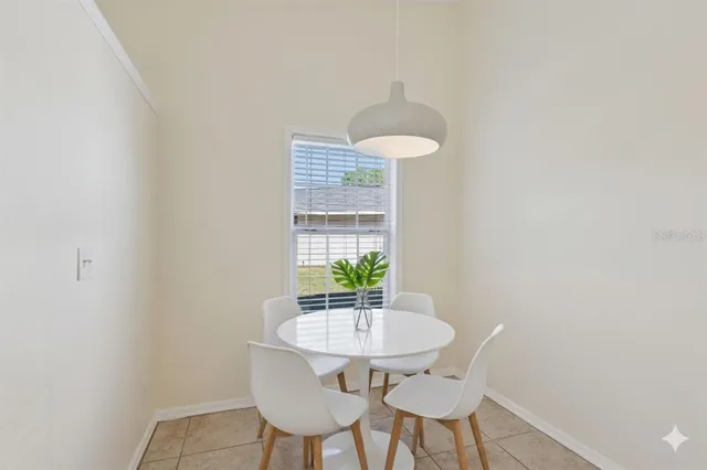 a view of a room with a table and chairs