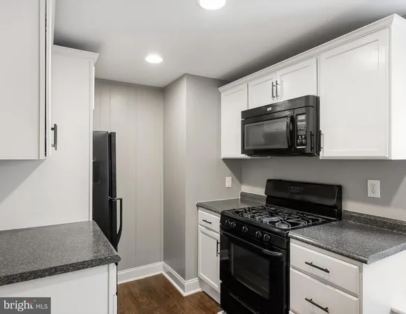 a kitchen with stainless steel appliances granite countertop a stove and a microwave
