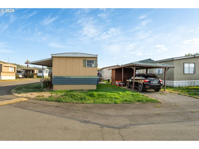 a front view of a house with a yard and a garage