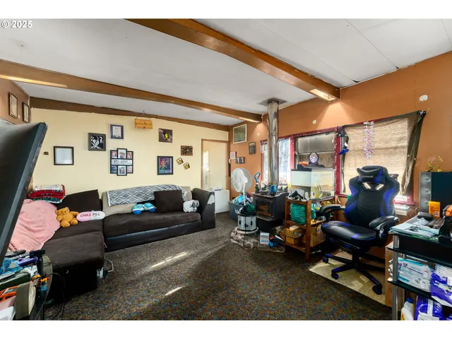 a living room with furniture a window and a flat screen tv