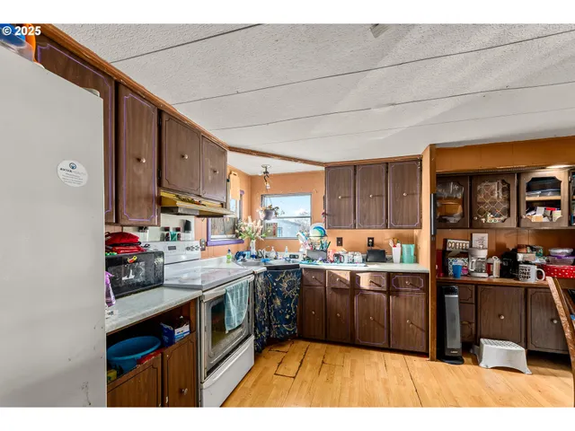 a kitchen with lots of counter top space and wooden floor
