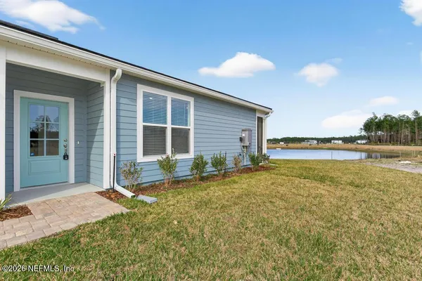 a utility room with stainless steel appliances kitchen island a refrigerator sink and cabinets