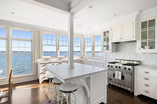 a kitchen with a stove a table and chairs in it