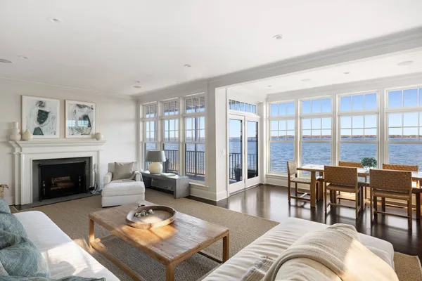 a living room with furniture dining table and a fireplace