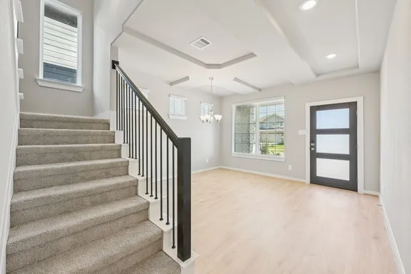 a view of entryway and hall with wooden floor