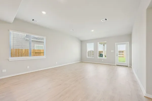 an empty room with windows and entrance