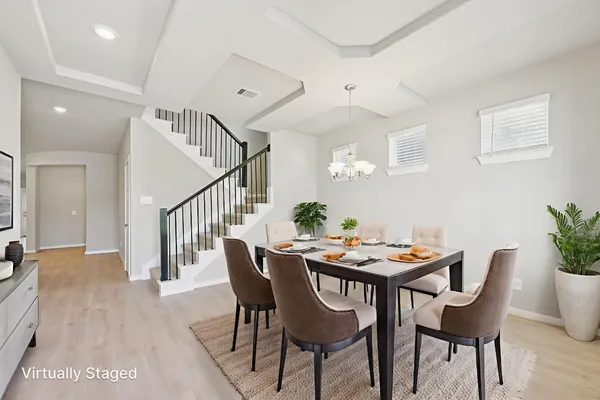 a view of a dining room with furniture and wooden floor