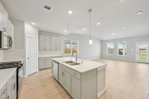 a kitchen with a sink stove and microwave