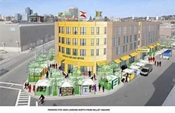 a front view of a multi story residential apartment building with parking