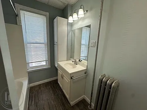 a bathroom with a sink a toilet and mirror