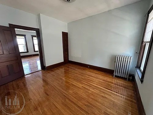 30 Pattison Street, Unit 2 Worcester, MA 01604 - Photo 30 of 32 a view of an empty room with wooden floor and a window