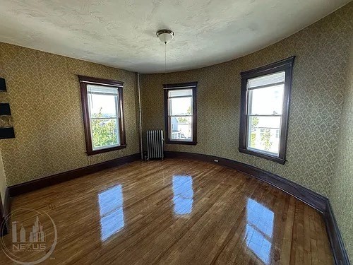 30 Pattison Street, Unit 2 Worcester, MA 01604 - Photo 31 of 32 a view of an empty room with wooden floor and a window