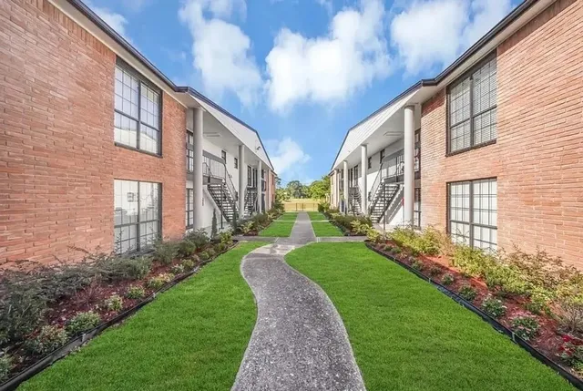 a view of a building with a yard