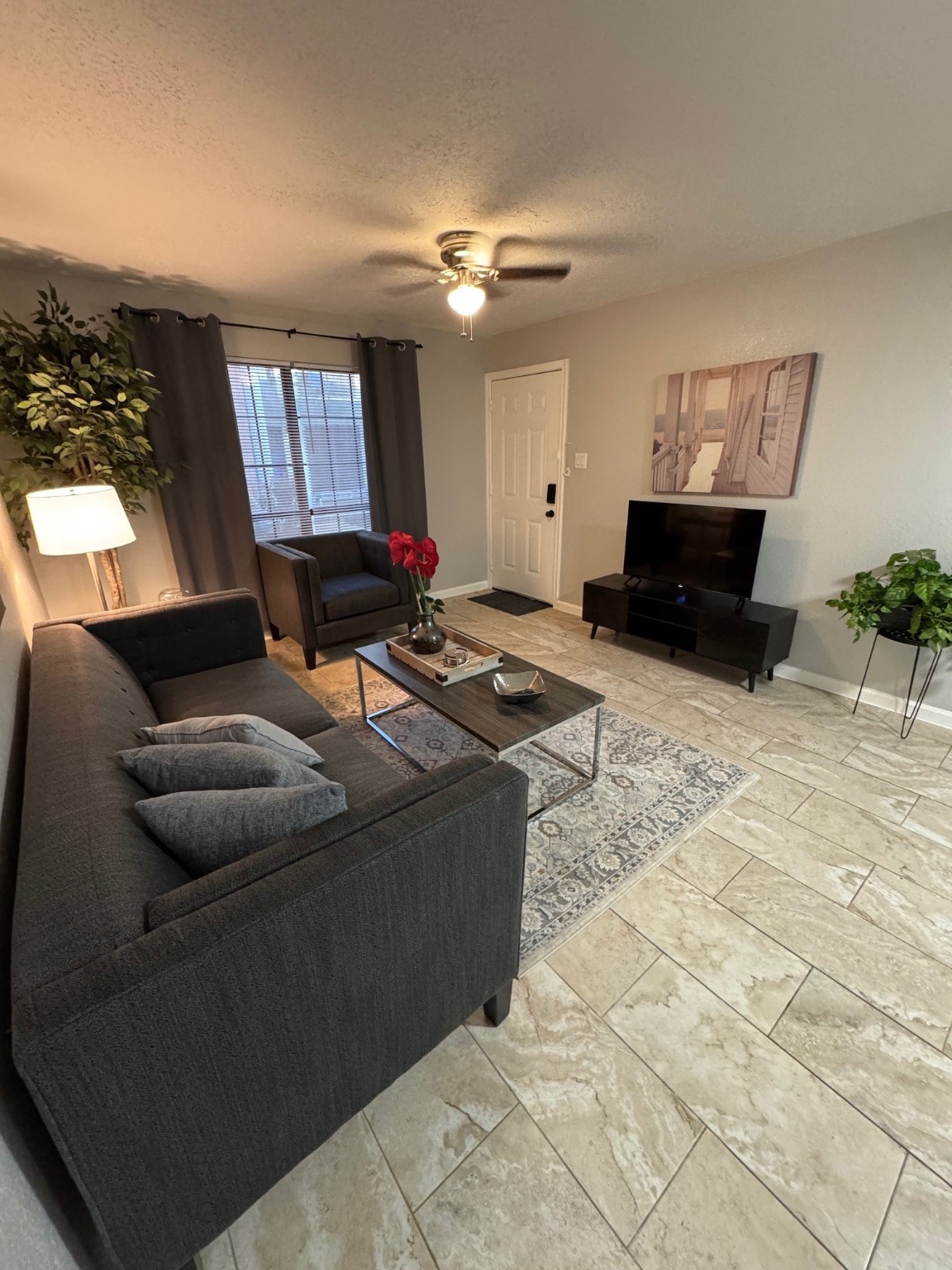 3316 North MacGregor Way, Unit 4 Houston, TX 77004 - Photo 2 of 37 a living room with furniture and a chandelier