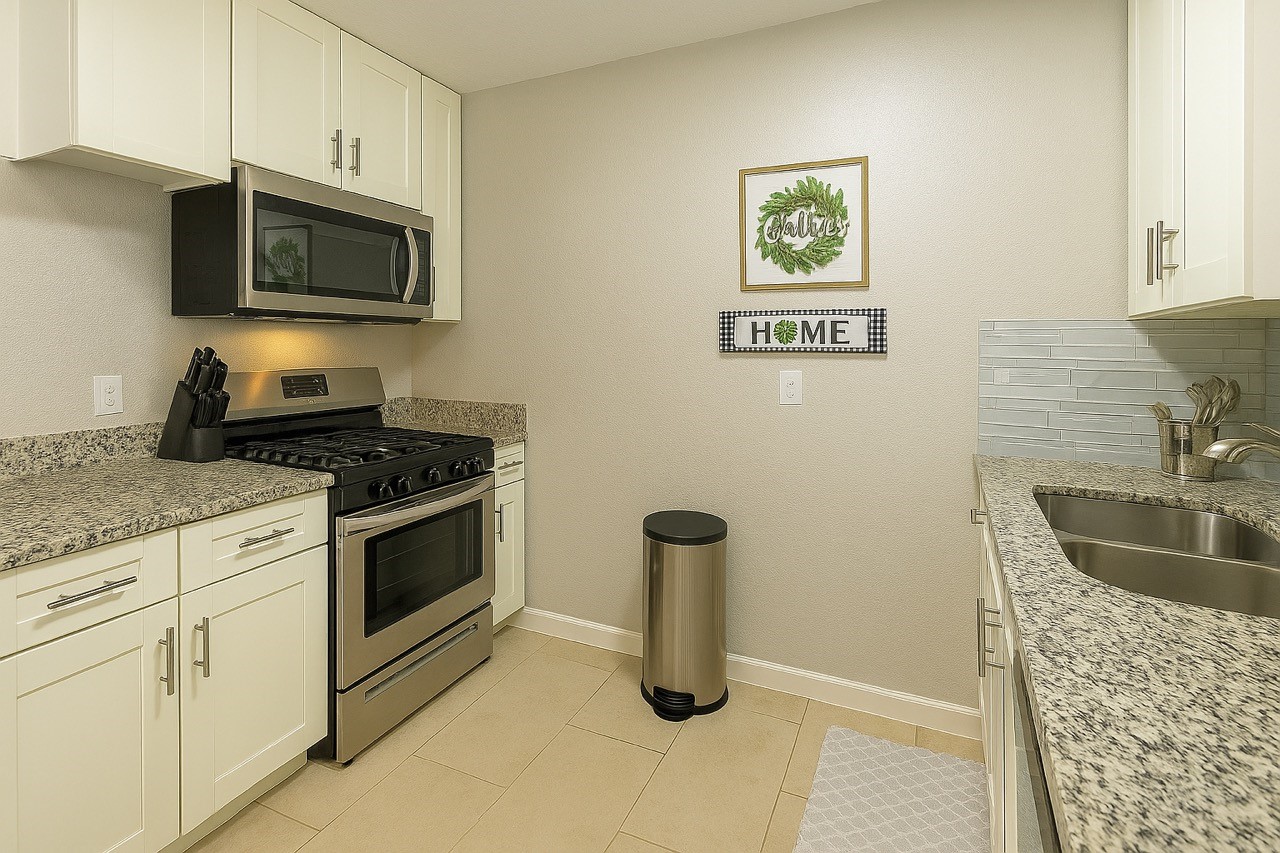 3316 North MacGregor Way, Unit 4 Houston, TX 77004 - Photo 6 of 37 a kitchen with granite countertop a sink stove and microwave