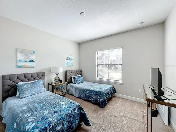 a bedroom with two beds and a window