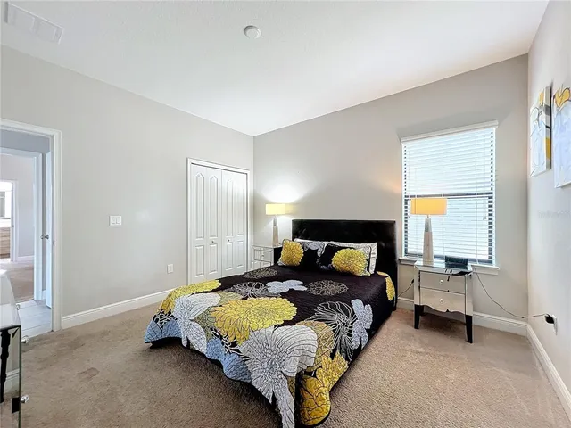 a spacious bedroom with a bed and a table in it