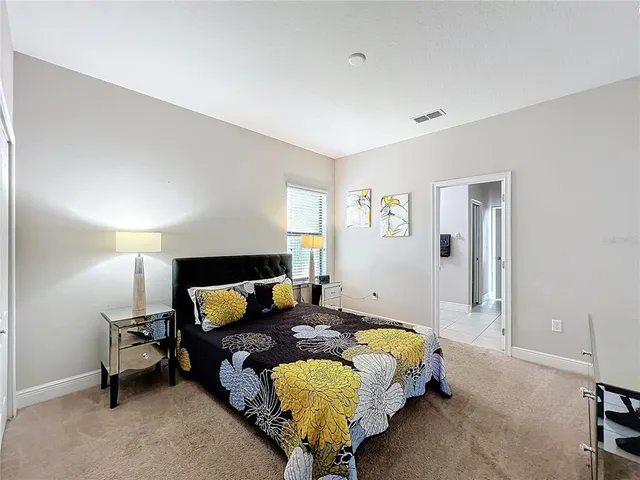 a bedroom with a bed and lamp