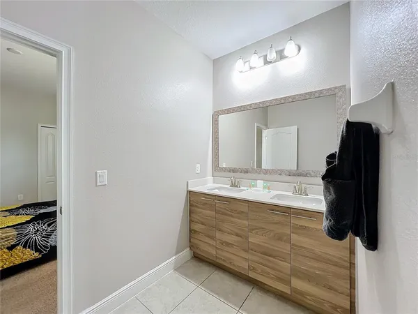 a bathroom with a double vanity sink and mirror