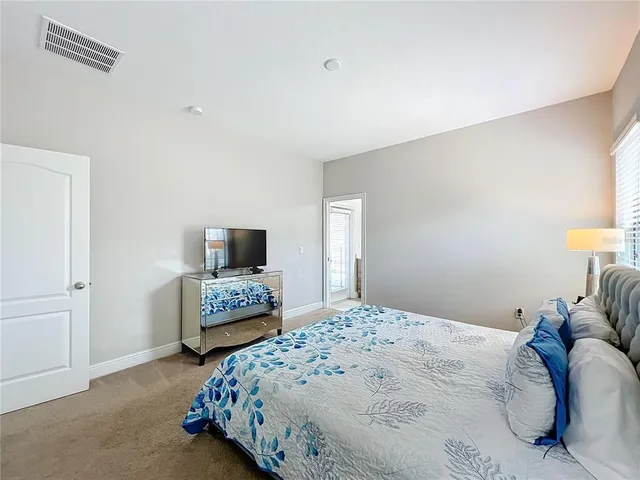 a bedroom with a bed and a couch