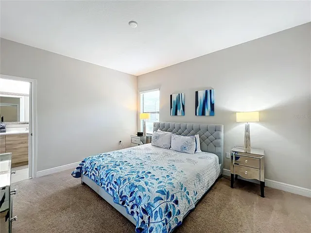 a bedroom with a bed and a lamp with window