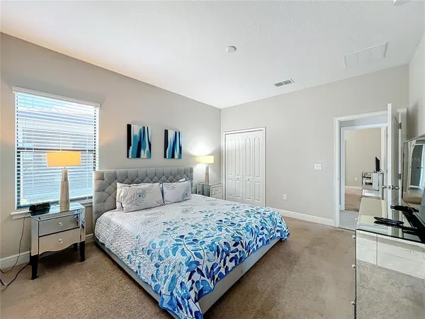 a bedroom with a bed a couch and dresser