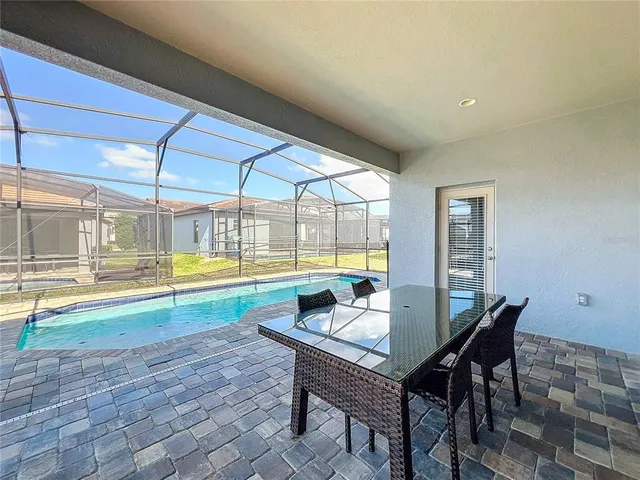a view of a dining room with a table and chairs