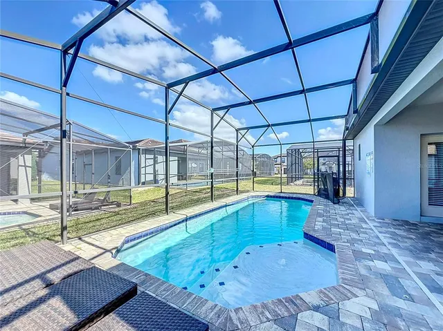 a view of a swimming pool with a patio