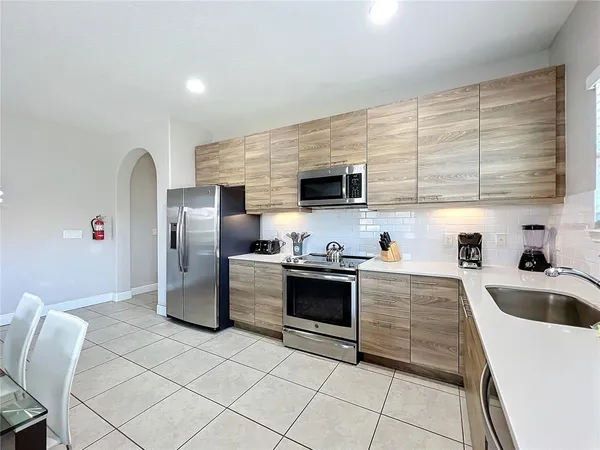 a kitchen with a sink cabinets and stainless steel appliances