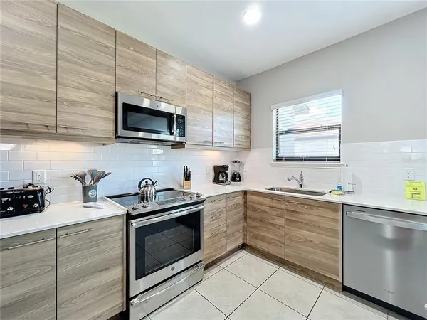 a kitchen with a sink cabinets and window