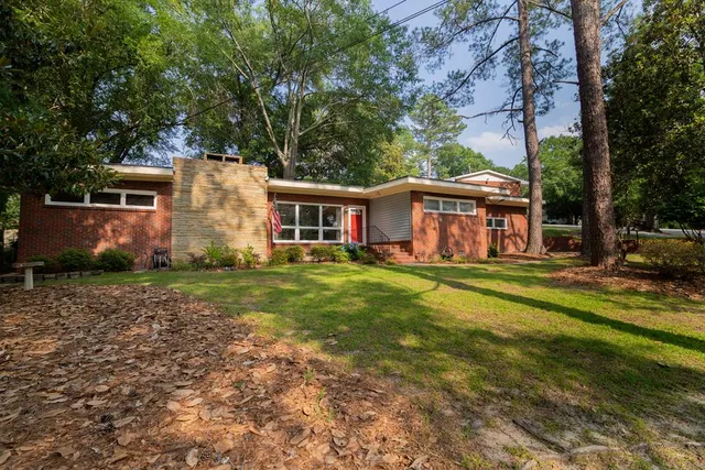 a front view of a house with a garden