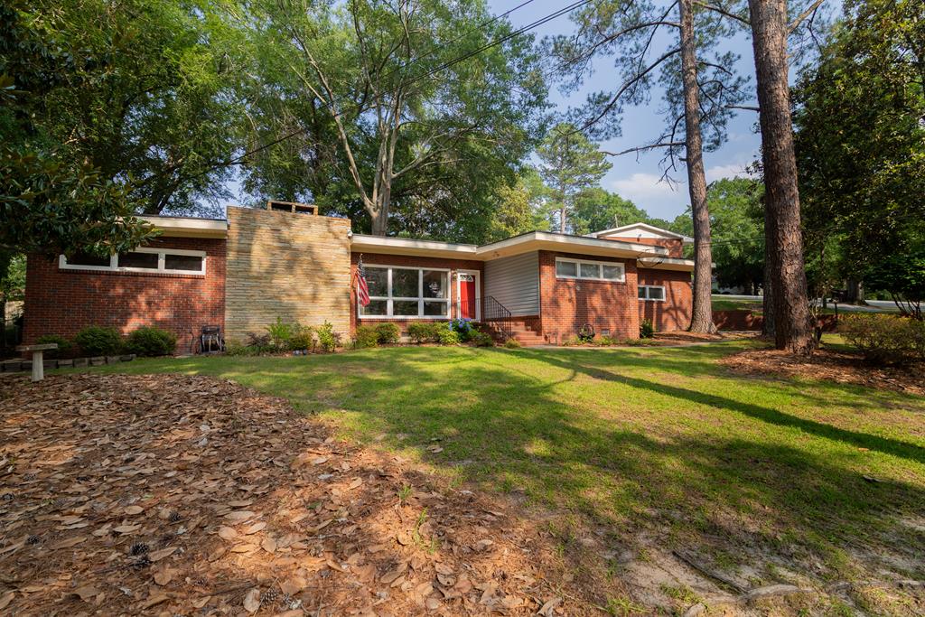 a front view of a house with a garden