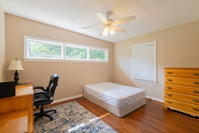 a bedroom with a bed and a desk