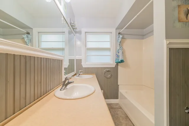 a bathroom with a sink a bathtub and a shower