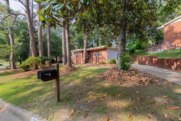 a view of a house with backyard and sitting area